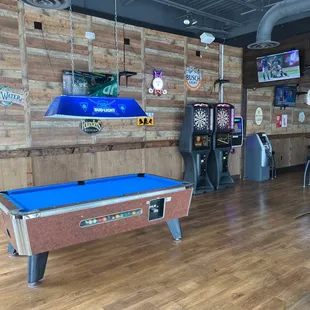 a pool table and arcade machines
