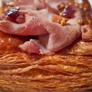 Ham croissant w/ whole gran mustard and honey poached ohi'a 'ai (close-up)