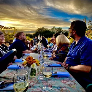 a group of people sitting at a dinner table