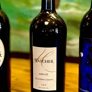 three bottles of wine on a table