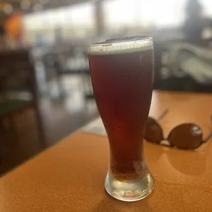 a glass of beer on a table