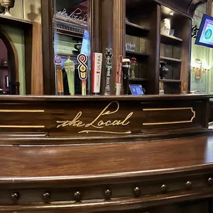 a wooden bar with a sign on it