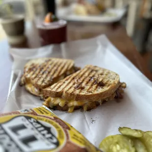 a grilled sandwich and pickles