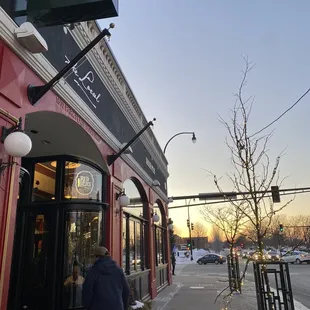 a woman walking down the sidewalk