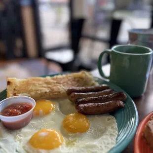 a breakfast of eggs, sausage and toast