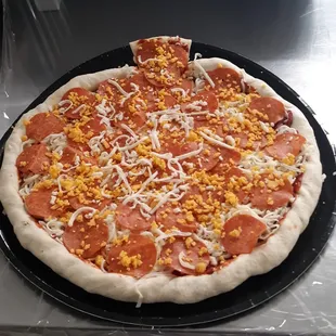 a pepperoni and corn pizza