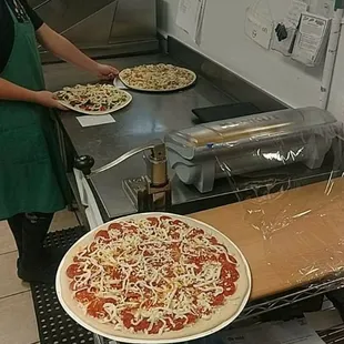 Pizza production in progress.