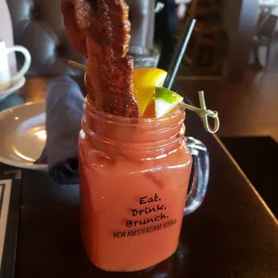 a drink with bacon in a mason jar