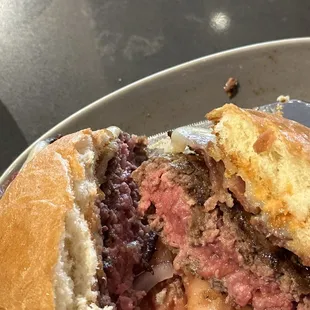 A raw hamburger that was supposed to be medium.