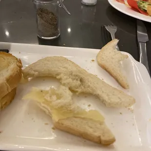 One small slice of shriveled cheese in the center of the bread.