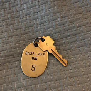a brass key with the name of the lodge on it