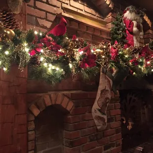 a fireplace decorated for christmas