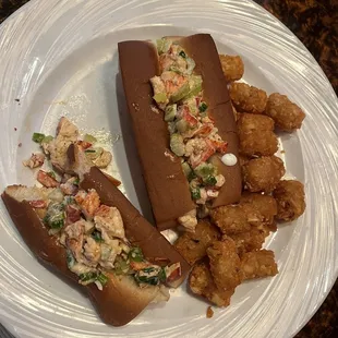 Lobster roll order with tater tots- delicious   I couldn&apos;t wait I took a bite before I took a picture!