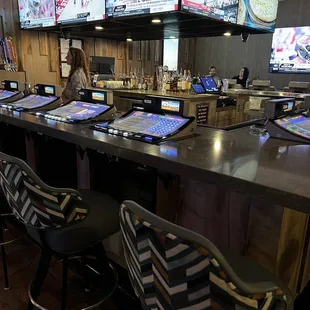 a bar with several laptops on it