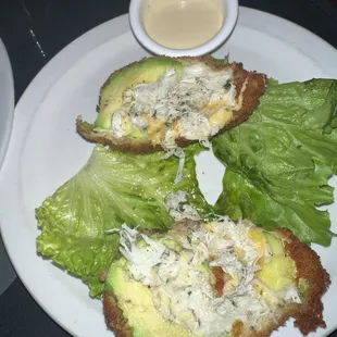 a plate of food with lettuce and cheese