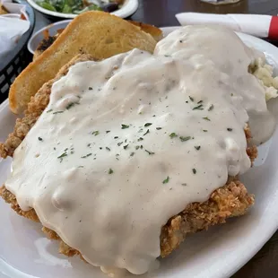 an Excellent Chicken fried steak with mashed potatoes and gravy along with Hush Puppies which I ate before taking a picture