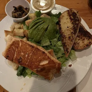 Salad with avocado, mushrooms and salmon added. Side of garlic bread.