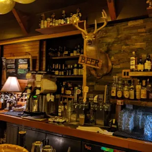a bar with a deer head on the wall