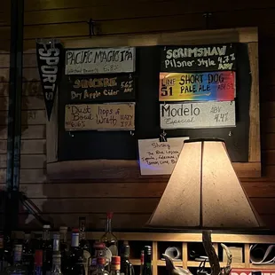 a table with a lamp and various liquors