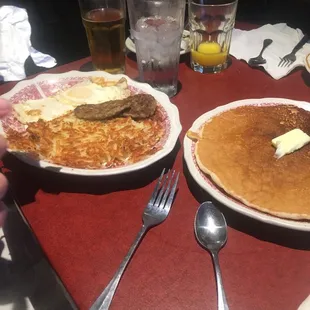 two plates of pancakes with butter and syrup