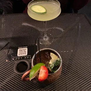 a cocktail and a strawberry