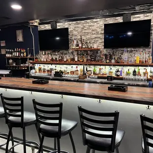 a bar with chairs