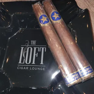 two cigars on a tray