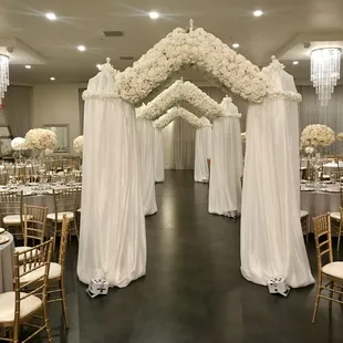 a large banquet hall decorated with white flowers