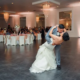 a bride and groom having their first dance