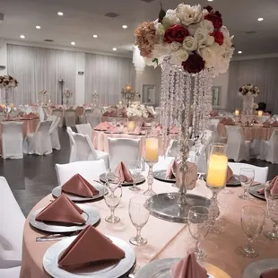 a large banquet room with tables, chairs, and centerpieces