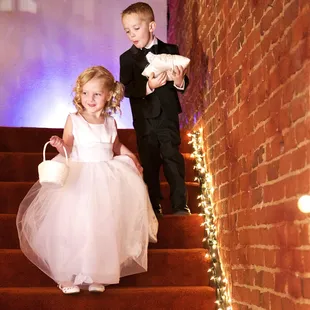 Flower girl and ring bearer entering down the stairs from the Loft Music Venue balcony