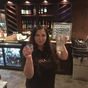 a woman holding a glass of water