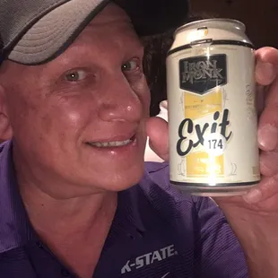 a man holding a can of beer