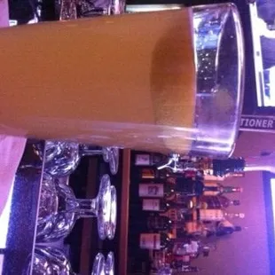 a glass of orange juice on a bar