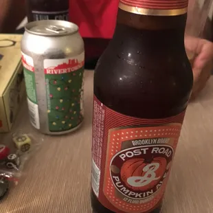 a man sitting at a table with a bottle of beer
