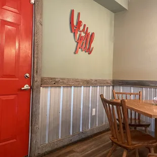 a dining room with a red door