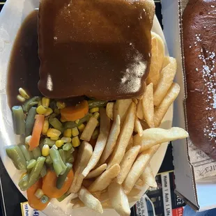 Hot roast beef sandwich, with steak fries and mixed vegetables.