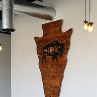 a cow on a wooden sign