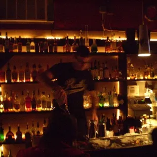 a man playing a guitar in front of the bar