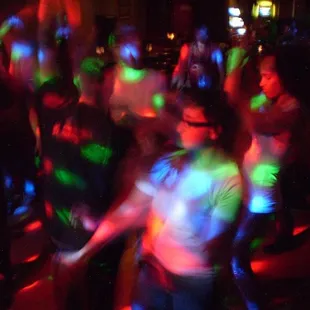 a group of people dancing at a party