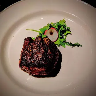 a steak on a white plate