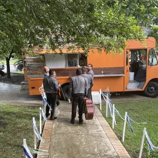 The Lone Star Food Truck fixing 6 cheeseburgers for the, Mariachi Los Reyes.