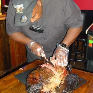 a man cutting a large piece of meat