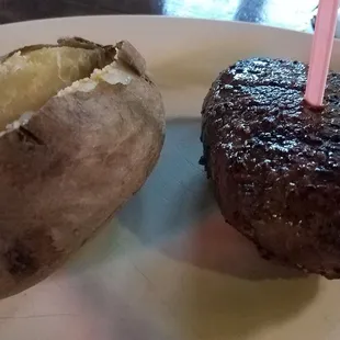 Steak, baked potato and salad (no shown) and potato topper bar