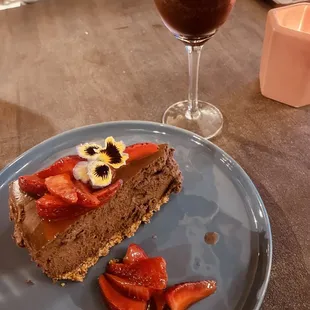 a slice of chocolate cheesecake with strawberries
