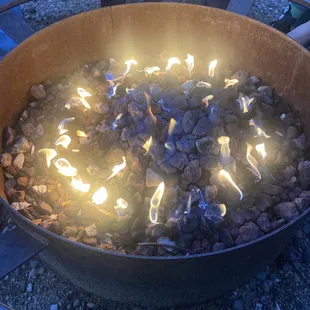 a fire pit with rocks and flames