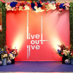 Step and repeat customized for our clients event with festive floral elaborations