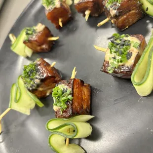 Pork belly skewers with a chili garlic aioli and black sesame seeds