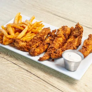 a plate of fried chicken strips and fries
