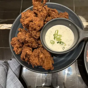 CRISPY CHICKEN BITES With buffalo spiced, ranch dip